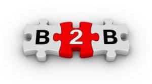 Three puzzle pieces connected, the central piece in red with the letter "b" and the adjacent white pieces having letters "b" and "2" to form the phrase "b2b.