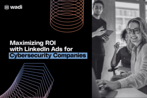 A promotional image for Wadi featuring text that reads "Maximizing ROI with LinkedIn Ads for Cybersecurity Companies." The background includes geometric shapes and a group of people, one standing and another seated, engaging with a laptop.