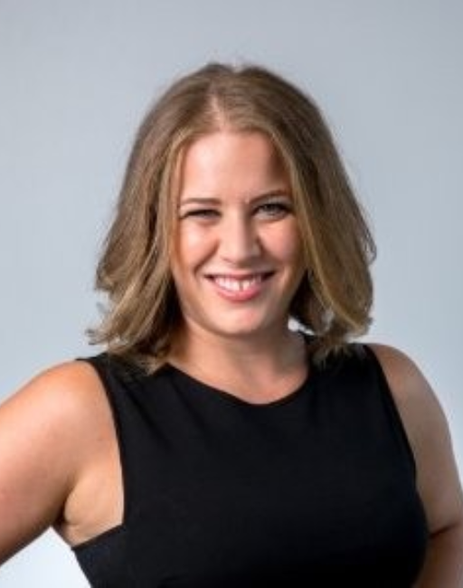 Woman with shoulder-length light brown hair smiles, wearing a sleeveless black top.