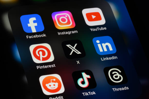 Smartphone screen showing icons for Facebook, Instagram, YouTube, X, LinkedIn, and other apps.